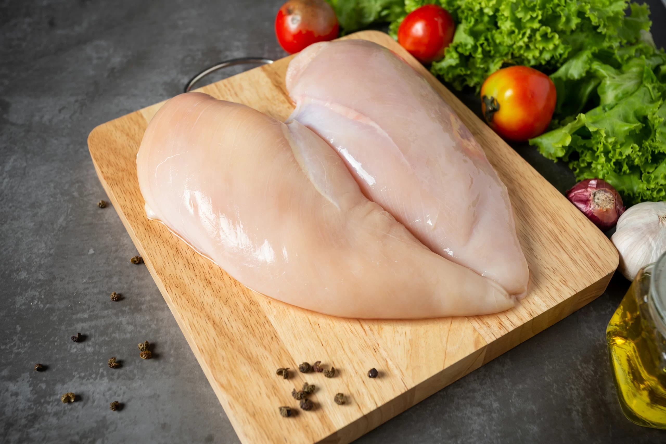 raw-chicken-breasts-wooden-cutting-board